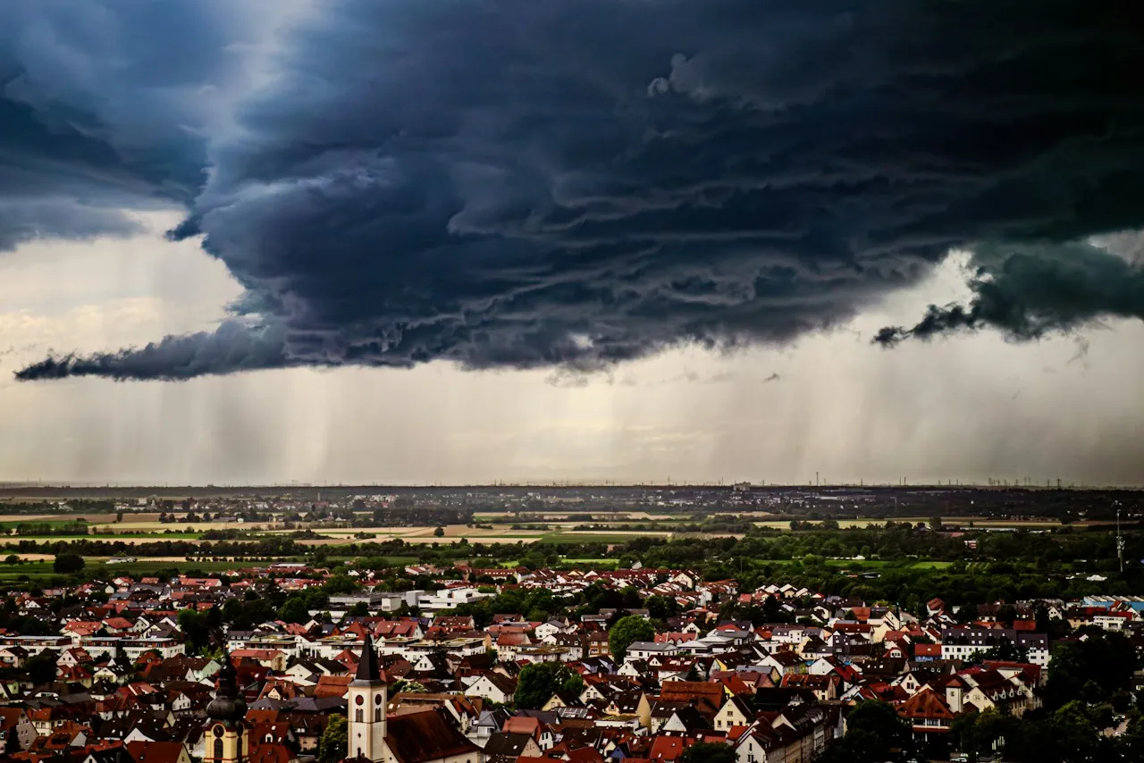 Roof Replacement in East Orange — a storm shelf cloud over a spread of rooftops